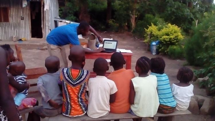 Joseph Kamara/ebola orphans/amputees and community in Sierra Leone, watching Geoff Lawton's quick garden.. 